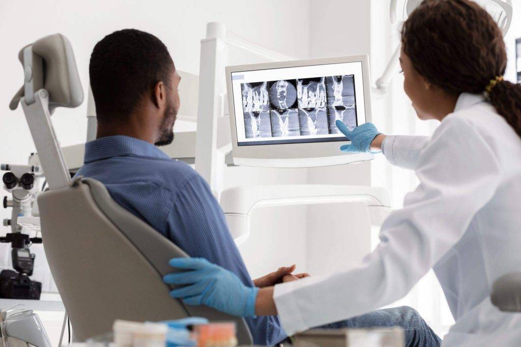 Man and medical professional review Xray in California office